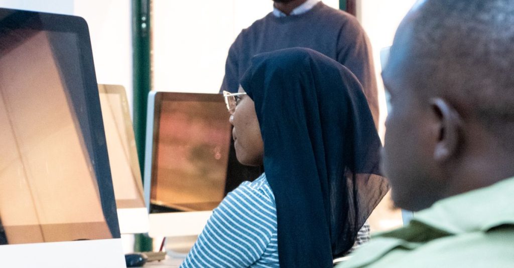 Students engaging in coding at a modern computer lab with a focus on ICT skills.