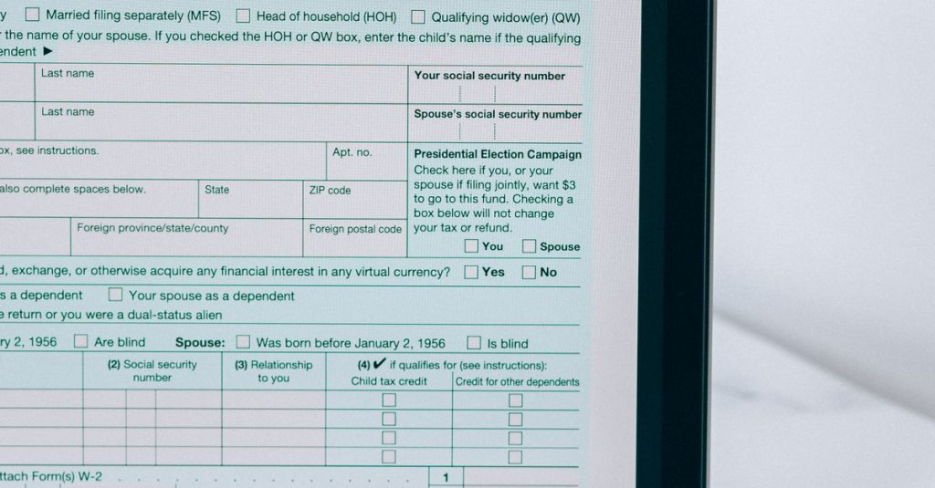 Laptop showing tax form with a reminder note, emphasizing tax payment.